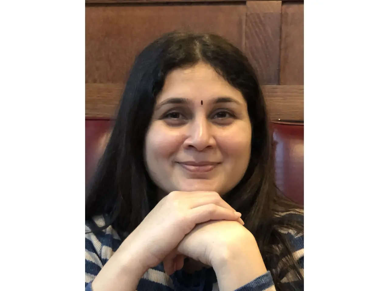 Woman with long black hair smiling