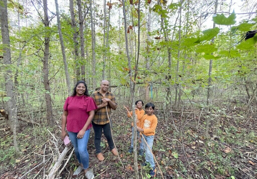 Family portrait in a wooded area.